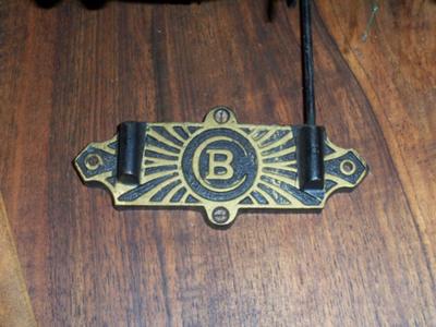 Brass plate with letter B inside letter C
